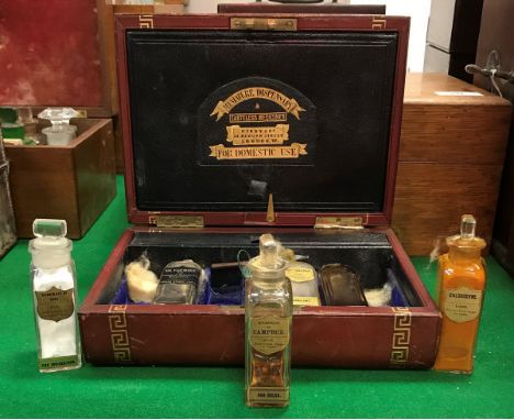 A Victorian leather-covered travelling apothecary's chest with tooled and gilded greek key banding, opening to reveal a fitte
