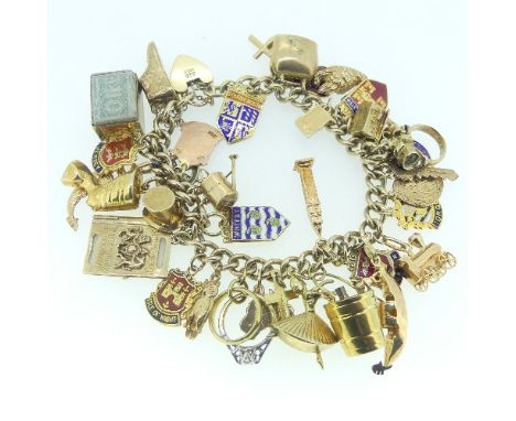 A 9ct yellow gold Bracelet,&nbsp;with 29 9ct gold charms suspended, including ballerina, shoe, hat, steam engine, a folded £1