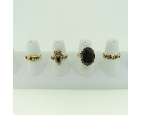 A 9ct sapphire and diamond Ring, the pear shaped central sapphire with a surround of diamonds and a diamond set bow surmount,