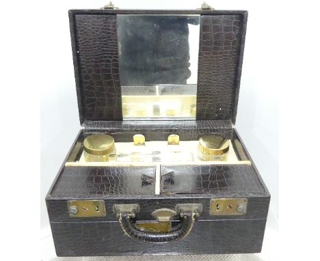 A vintage cased Gentleman's travelling Dressing Table Set,&nbsp;containing lidded jars, glove stretchers, etc, together with 