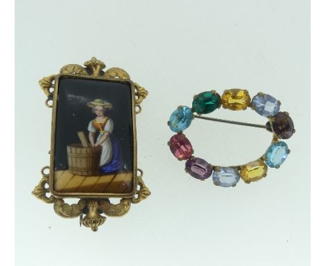 An attractive gilt metal Brooch, the centre with a rectangular ceramic painted plaque of a girl making butter, in scrolling m
