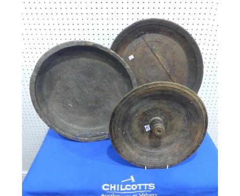 Three folk art and tribal wooden Bowls,&nbsp;hand turned, with splits and repairs, diameters ranging from 34.5cm to 47cm. 