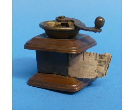 A vintage novelty Dressmakers' Measure, in the form of a Coffee Grinder (a/f) 