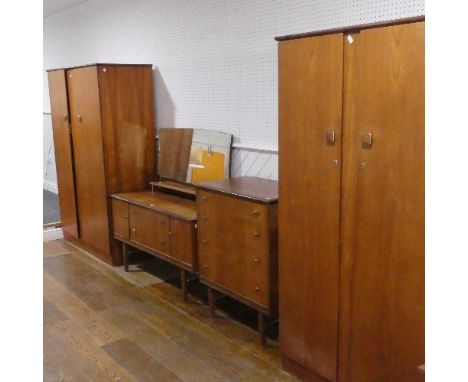 A vintage teak "Homeworthy" four piece Bedroom Suite - dressing table, chest of drawers and two wardrobes. Wardrobe 1 W x 124