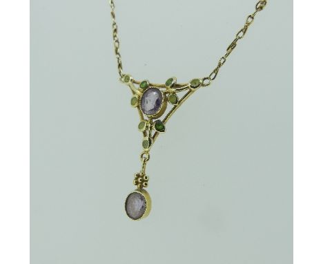 A 'Suffragette' style Pendant, of openwork foliate design with central amethyst and fixed amethyst drop below, millegrain set