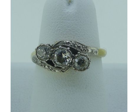 A diamond three stone crossover Ring,&nbsp;the centre stone approx 0.25ct with the outside stones approx 0.2ct, all mounted i