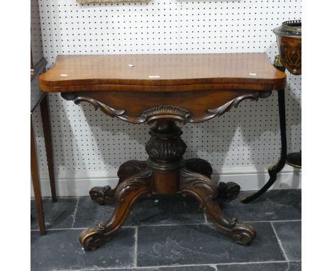 A Victorian mahogany fold-over Card Table, with shaped top raised on a carved and turned base, W 93cm x H 75cm x D 46cm