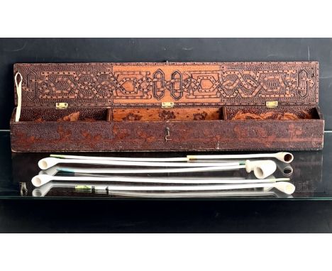 Five churchwarden clay pipes contained in a pokerwork arrow-case. The pipes by William Southorn &amp; Co. of Broseley, Shrops