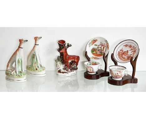 A pair of reproduction Staffordshire seated greyhounds with hares &ndash; 22cm high; together with two mid-19th&nbsp;century 