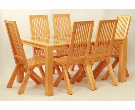 A solid light maple wood and glass extendable kitchen or dining table and six matching chairs - the rectangular glass-topped 