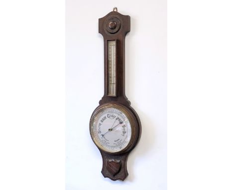 A 1920s oak aneroid wheel barometer - with 8in silvered dial and mercury thermometer, 78cm high.