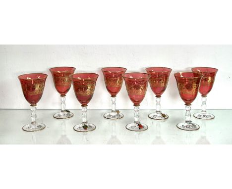 A set of eight ruby and gilt glass wine goblets - late 20th century, the bell shaped bowl with bands of gilt floral and leafy