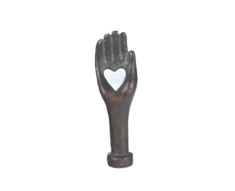 A patinated bronze novelty hand-shaped pipe tamper - probably 19th century, the hand pierced with a heart, 6.5cm long.