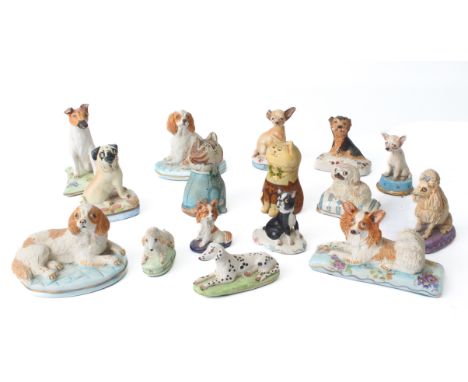 A small group of pottery miniatures figures of dogs by Basil Matthews &ndash; each seated upon a decorative cushion, most wit