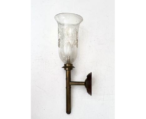 A brass and glass storm lamp &ndash; 20th&nbsp;century, the shade etched with fruiting vines, on a turned mahogany wall mount