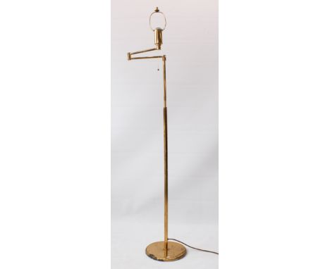 An adjustable brass reading lamp - the height adjusting from 137 cm to 171 cm high, the light on an adjustable swing arm, wit
