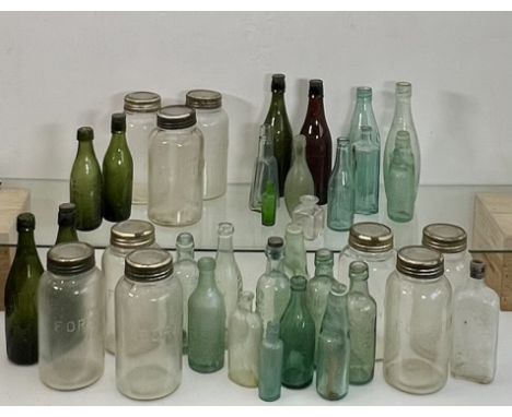 A collection of antique and vintage glass bottles and Forster Kilner style preserving jars