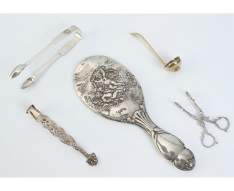 Four small pieces of silver and one white metal: an ornate hand-mirror decorated with putti, Chester 1902; a silver-gilt sift