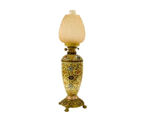 Budapest porcelain oil lamp with typical scrolled foliate decoration and gilded highlights upon a cast bronze stand and fitte