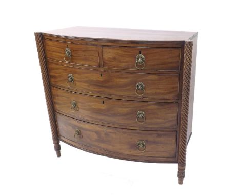 Regency mahogany bow fronted chest of drawers, fitted with two short over three long graduated drawers applied with lion head