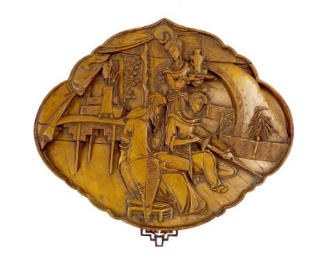 Japanese carved boxwood relief panel decorated with an interior scene with figures and weaponry, 13" wide x 11" high