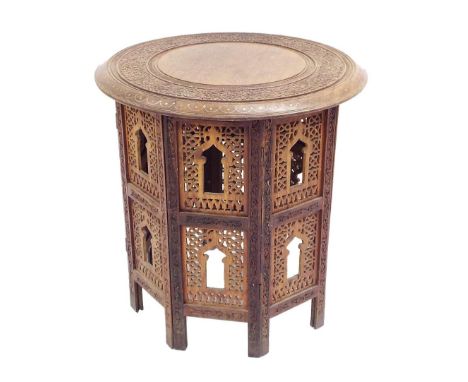 Eastern hardwood copper and brass inlaid folding table, the circular top centrally decorated with an inlaid floral panel with