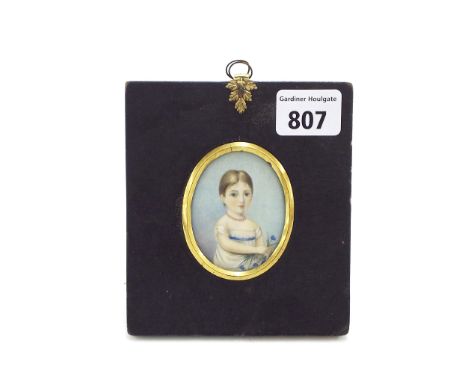 19th Century School - half length portrait of a girl holding blue flowers, miniature work on ivory, oval mount, 2.5" x 2"