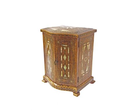 Decorative Eastern inlaid bow fronted specimen cabinet, decorated all over with mother of pearl and copper wire inlay, the tw