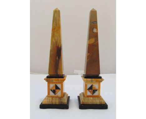 A pair of Egyptian revival marble monolithic pillar obelisks on inlaid stepped square bases, 34cm (h)