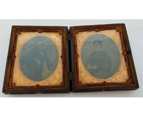 Two ambrotype portrait photographs of a lady and gentleman, gilt surrounds, in a carved vulcanite union case decorated with b