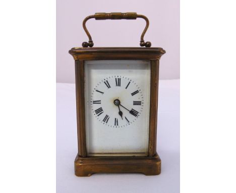 A brass cased carriage clock of customary form with white enamel dial and Roman numerals, 12cm (h)