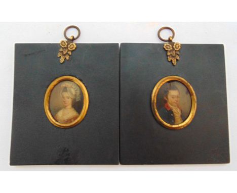 A pair of framed portrait miniatures of a gentleman wearing a blue coat and lady with lace hat, images 3.5 x 3cm frames 10.5 
