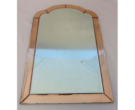 An Art Deco style wall mirror of rectangular form with arched top and peach glass border, 76.5 x 51.5cm