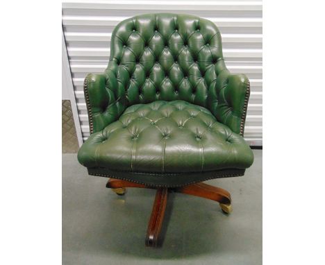 A green leatherette button back office desk chair on original castors
