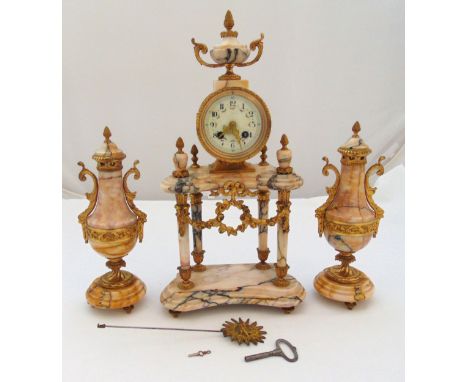 A late 19th century French pink marble mantle clock, white enamel dial with Arabic numerals with vase form garnitures to incl