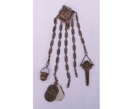 A white metal filigree Chatelaine to include note pad, scissors case and thimble case