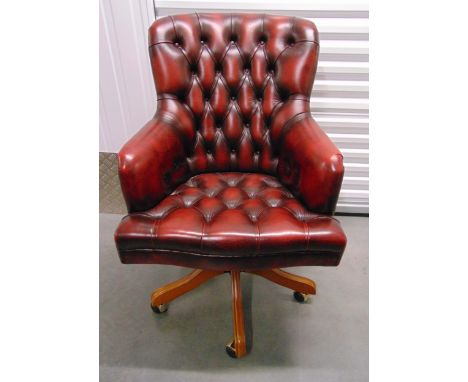 A leatherette button back office desk chair on original castors