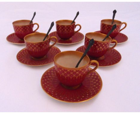 A set of six Royal Worcester coffee cans and saucers and six hallmarked coffee spoons London 1977