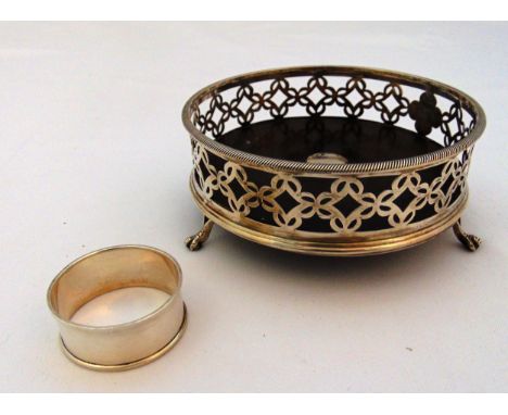 A Victorian hallmarked silver coaster with scroll pierced sides on three ball and claw feet and ebony base Birmingham 1852 an