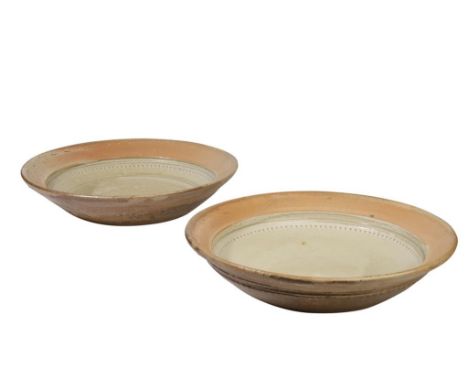 RICHARD BATTERHAM (B.1936): TWO LARGE STUDIO POTTERY BOWLS, circular form, incised tooth border with a celadon glaze, impress