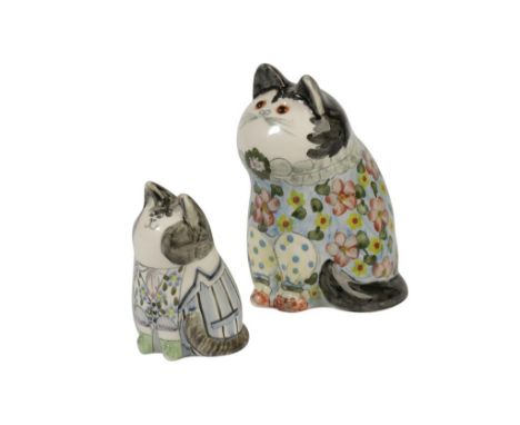 FROM AN ORIGINAL DESIGN OF JOAN DE BETHEL: TWO CERAMIC CATS, c.1997, each wearing coats and painted in polychrome, Cinque Por