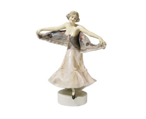 GOLDSCHEIDER: AN ART DECO CERAMIC FIGURE, entitled "Podola", modelled as a female dancer, outstretched arms holding her dress