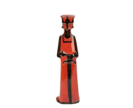 DAVID SHARP FOR RYE POTTERY: A CERAMIC CANDLESTICK, c.1960, in the form of a stylised king, in tones of red and black, painte