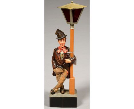 A POLYCHROMED WOOD WHISTLING TRAMP AUTOMATON, STANDING BESIDE A LAMP POST WITH METAL LANTERN, 47CM H, BASE INSCRIBED TOM SEAL