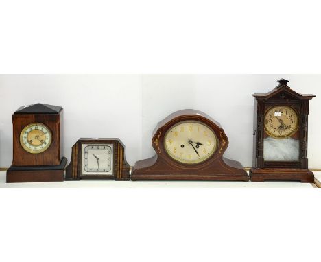 A STAINED WOOD SHELF CLOCK, TWO OTHER MAHOGANY OR STAINED WOOD MANTEL CLOCKS AND A TIMEPIECE, EARLY 20TH C  All require some 