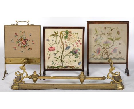 AN EDWARDIAN BRASS FIRESCREEN AND TWO OTHERS, EACH WITH WOOLWORK OR EMBROIDERED BANNER, VARIOUS SIZES AND A CONTEMPORARY EDWA