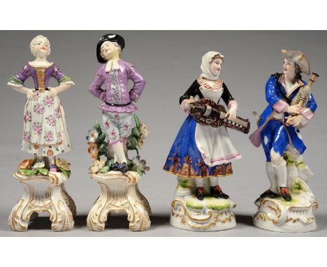 A PAIR OF GERMAN PORCELAIN FIGURES OF ITINERANT MUSICIANS PLAYING THE HURDY-GURDY OR BAGPIPES, ON GILT MOUND WITH ROCAILLE, 1