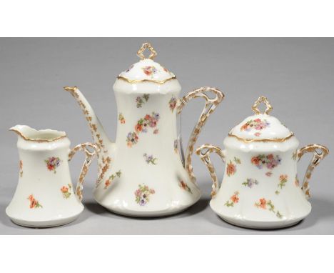 AN ART NOUVEAU LIMOGES TEA SET OF TEAPOT AND COVER, SUCRIER AND COVER AND MILK JUG, WITH PIERCED HANDLE[S], PRINTED AND PAINT