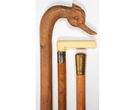 A MALACCA WALKING CANE WITH BONE HANDLE, ANOTHER WITH GILT BRASS POMMEL, 90 AND 86CM L AND A LATER CARVED WOOD WALKING STICK,