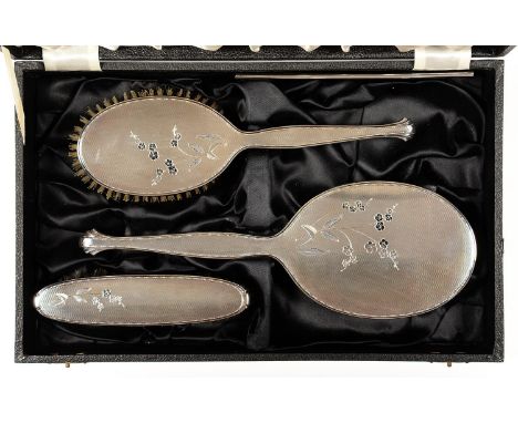 AN ELIZABETH II SILVER FOUR PIECE BRUSH SET, ENGRAVED WITH BLOSSOM AND ENGINE TURNED, BY ADIE BROTHERS LIMITED, BIRMINGHAM 19